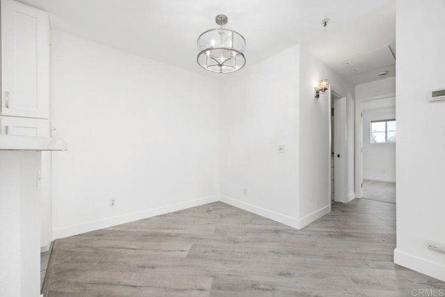 11375 Affinity Ct Unit 206, San Diego, CA 92131 - unfurnished dining area featuring light wood finished floors and a chandelier