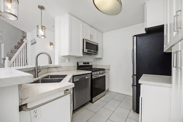 11375 Affinity Ct Unit 206, San Diego, CA 92131 - kitchen featuring appliances with stainless steel finishes, white cabinets, light stone counters, a peninsula, and decorative light fixtures