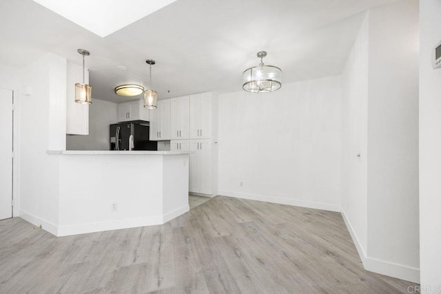 11375 Affinity Ct Unit 206, San Diego, CA 92131 - kitchen featuring black refrigerator with ice dispenser, light wood finished floors, white cabinets, and light countertops