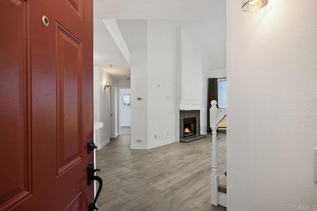 11375 Affinity Ct Unit 206, San Diego, CA 92131 - foyer entrance featuring light wood-style flooring and a tile fireplace