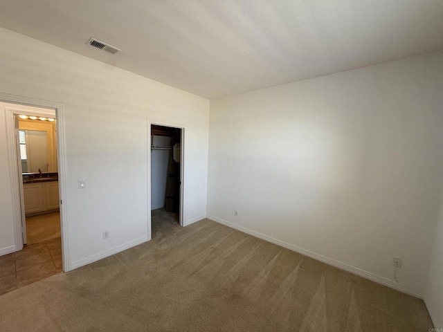 106 Chesapeake Ct, San Marcos, CA 92069 - unfurnished bedroom with carpet, a walk in closet, and ensuite bathroom