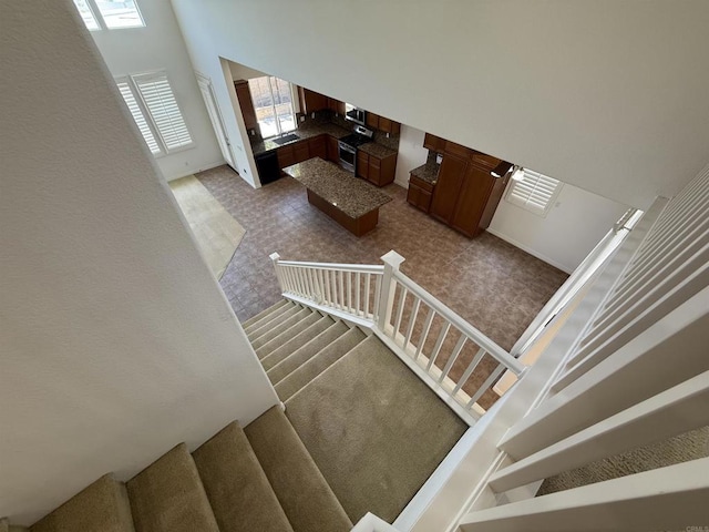 106 Chesapeake Ct, San Marcos, CA 92069 - staircase with a towering ceiling and baseboards