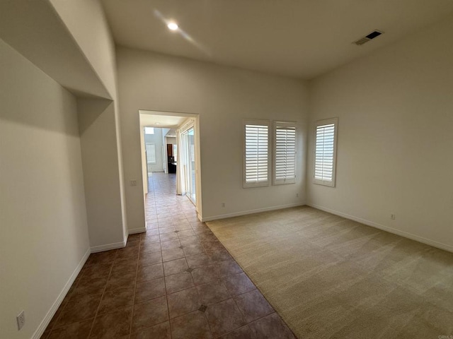 106 Chesapeake Ct, San Marcos, CA 92069 - empty room with dark colored carpet, dark tile patterned flooring, and recessed lighting