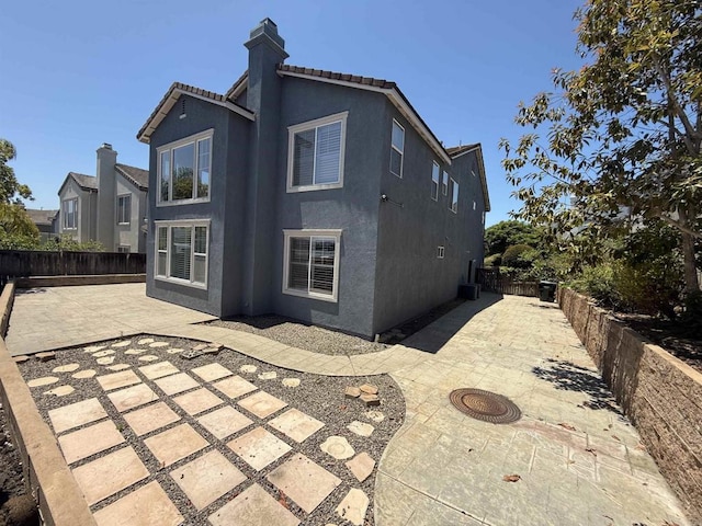 106 Chesapeake Ct, San Marcos, CA 92069 - rear view of property with a patio, a fenced backyard, stucco siding, and a chimney