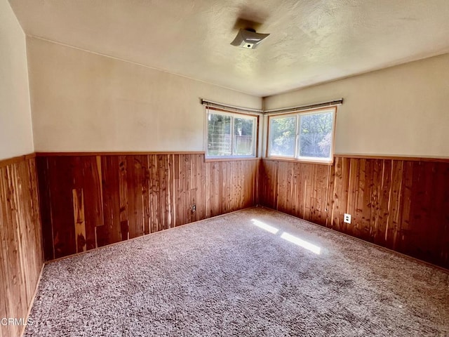 21560 Bald Hill Rd, Fort Bragg, CA 95437 - empty room featuring wood walls, a wainscoted wall, and carpet floors