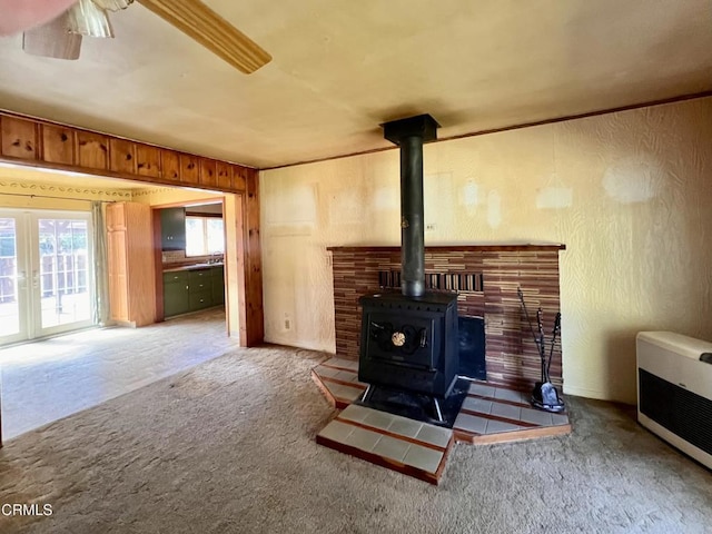 21560 Bald Hill Rd, Fort Bragg, CA 95437 - living area featuring a wood stove, heating unit, and carpet flooring