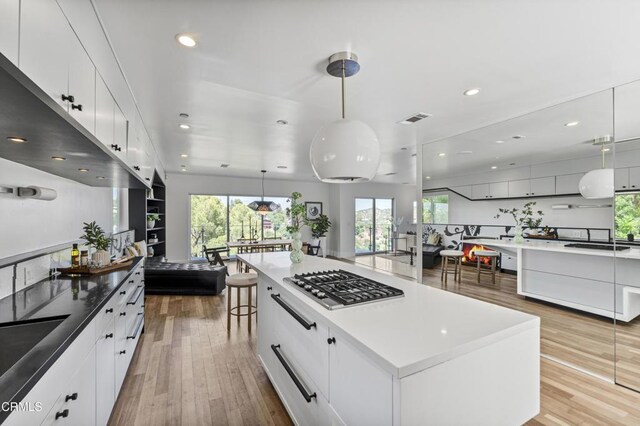 453 Frontenac Ave, Los Angeles, CA 90065 - kitchen with stainless steel gas cooktop, modern cabinets, white cabinets, light wood-type flooring, and recessed lighting