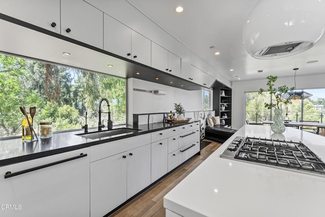 453 Frontenac Ave, Los Angeles, CA 90065 - kitchen featuring dark wood-type flooring, white cabinets, stainless steel gas stovetop, recessed lighting, and dark countertops
