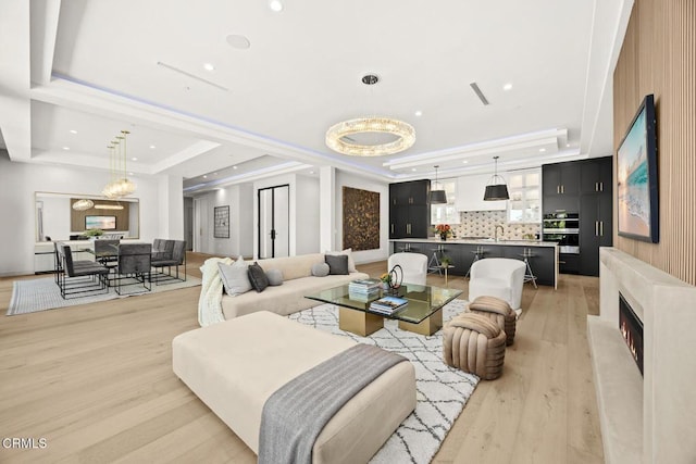 4828 Oakwood Ave, La Canada Flintridge, CA 91011 - living room featuring a tray ceiling, light wood-type flooring, recessed lighting, and a high end fireplace