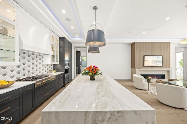 4828 Oakwood Ave, La Canada Flintridge, CA 91011 - kitchen with appliances with stainless steel finishes, decorative backsplash, light wood-type flooring, light stone countertops, and recessed lighting