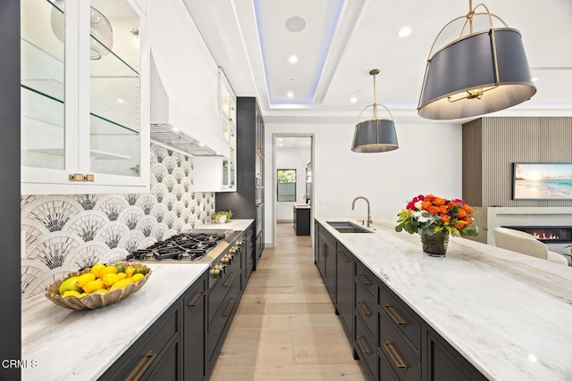 4828 Oakwood Ave, La Canada Flintridge, CA 91011 - kitchen featuring light wood-style floors, backsplash, light stone counters, white cabinetry, and dark cabinets