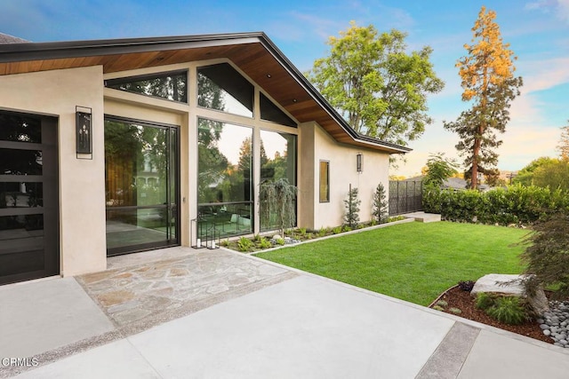 4828 Oakwood Ave, La Canada Flintridge, CA 91011 - exterior entry at dusk featuring a patio and stucco siding