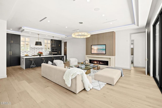 4828 Oakwood Ave, La Canada Flintridge, CA 91011 - living room with a raised ceiling, light wood-style flooring, recessed lighting, and a large fireplace