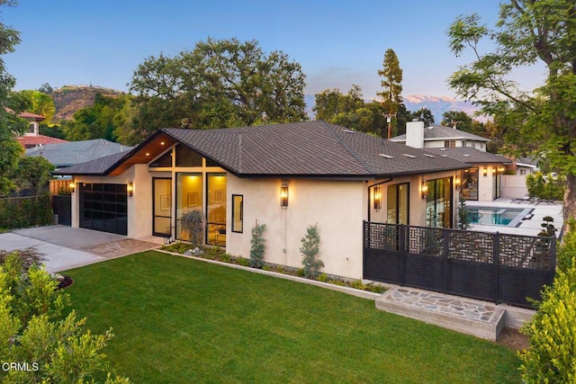 4828 Oakwood Ave, La Canada Flintridge, CA 91011 - view of front facade with stucco siding, concrete driveway, an attached garage, and a chimney