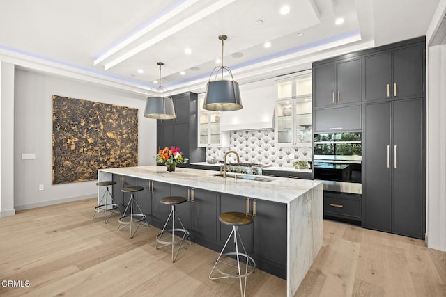 4828 Oakwood Ave, La Canada Flintridge, CA 91011 - kitchen with a tray ceiling, backsplash, a spacious island, light stone countertops, and recessed lighting