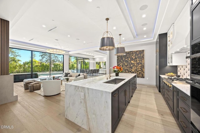 4828 Oakwood Ave, La Canada Flintridge, CA 91011 - kitchen with stainless steel gas stovetop, healthy amount of natural light, a large island with sink, light stone countertops, and recessed lighting