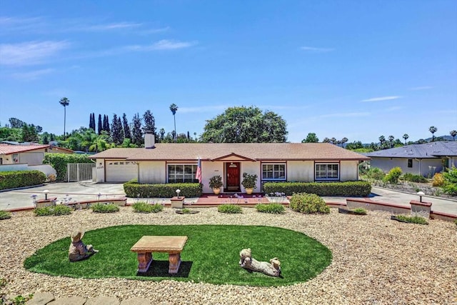1235 Via Rancho Pkwy, Escondido, CA 92029 - single story home with an attached garage, driveway, and a chimney