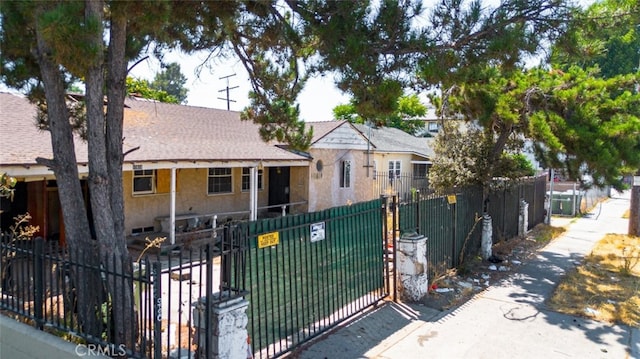 11618 Victory Blvd, North Hollywood, CA 91606 - view of front of property featuring a gate, roof with shingles, and stucco siding