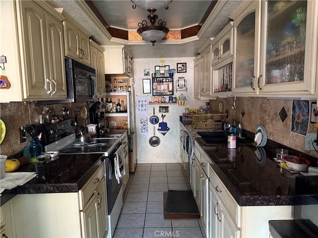 32078 Del Cielo Oeste, Bonsall, CA 92003 - kitchen featuring electric range oven, black microwave, light tile patterned flooring, backsplash, and cream cabinetry