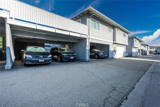 28023 Robin Ave, Saugus, CA 91350 - view of home's exterior with covered parking, stucco siding, and a residential view