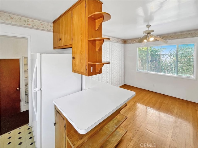 11753 Kling St, Valley Village, CA 91607 - kitchen featuring open shelves, light wood finished floors, light countertops, freestanding refrigerator, and a ceiling fan