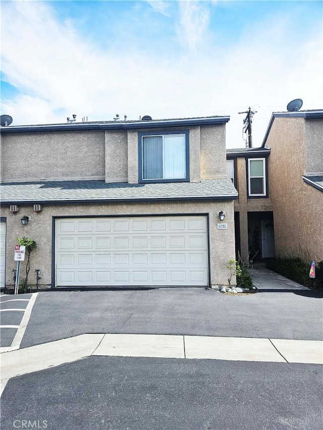 675 N Lark Ellen Ave, Covina, CA 91722 - traditional-style house with stucco siding, an attached garage, and asphalt driveway