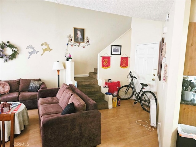 675 N Lark Ellen Ave, Covina, CA 91722 - living area with stairs, light wood-type flooring, and a textured ceiling