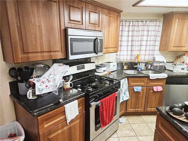 675 N Lark Ellen Ave, Covina, CA 91722 - kitchen with appliances with stainless steel finishes, light tile patterned floors, and brown cabinetry