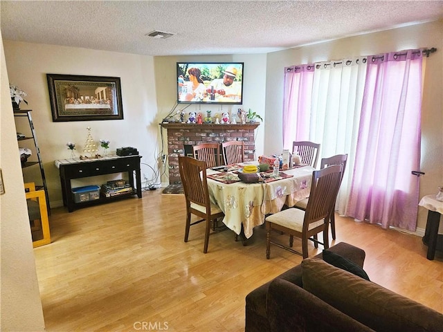 675 N Lark Ellen Ave, Covina, CA 91722 - dining space with light wood-style floors and a textured ceiling
