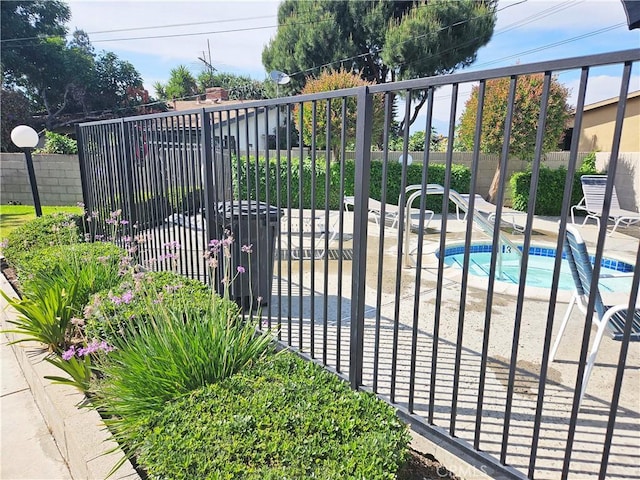 675 N Lark Ellen Ave, Covina, CA 91722 - gate with a pool and a patio area