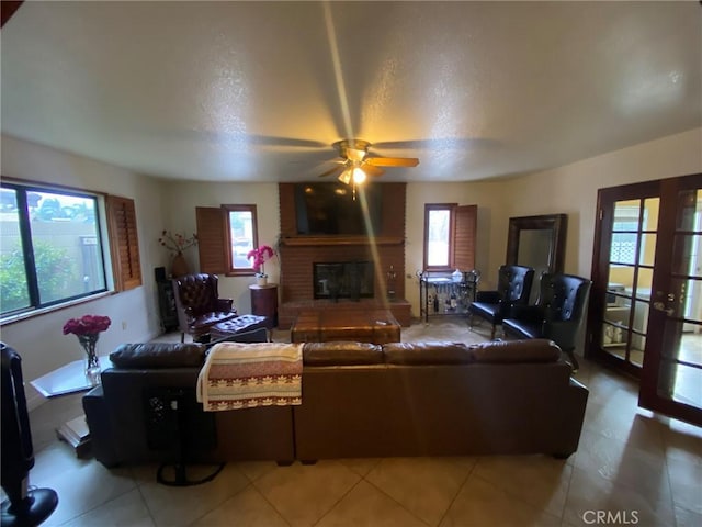 4323 Annisa Ave, Hemet, CA 92544 - living area featuring a brick fireplace, ceiling fan, a textured ceiling, and light tile patterned floors