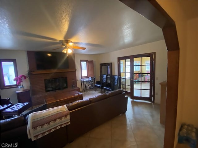 4323 Annisa Ave, Hemet, CA 92544 - living area featuring a brick fireplace, ceiling fan, and light tile patterned floors