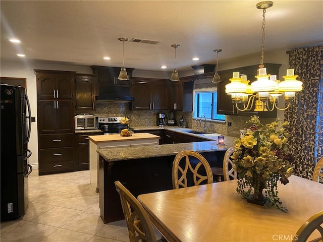 4323 Annisa Ave, Hemet, CA 92544 - kitchen featuring freestanding refrigerator, stainless steel electric stove, under cabinet range hood, dark brown cabinets, and backsplash