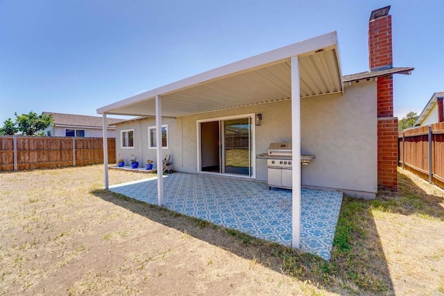 1547 Cochabamba St, San Diego, CA 92154 - rear view of property featuring a chimney, a fenced backyard, stucco siding, and a patio area
