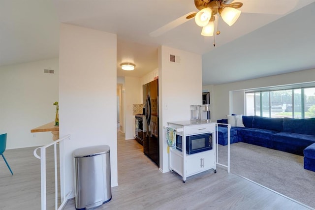 1547 Cochabamba St, San Diego, CA 92154 - kitchen featuring black appliances, light wood-type flooring, open floor plan, and ceiling fan