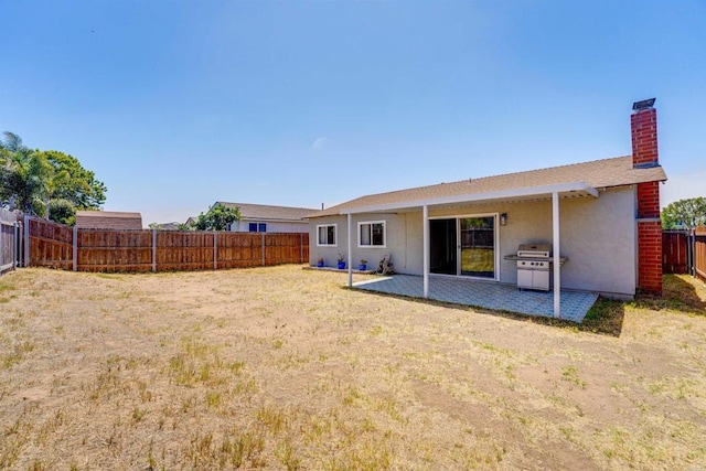 1547 Cochabamba St, San Diego, CA 92154 - back of property with a fenced backyard, stucco siding, a patio area, and a chimney