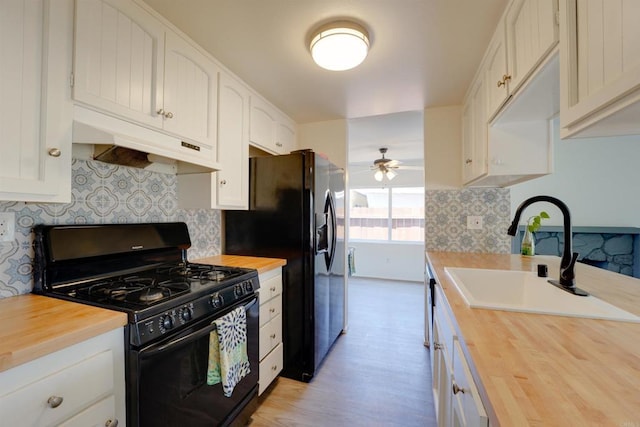 1547 Cochabamba St, San Diego, CA 92154 - kitchen with black appliances, wooden counters, ventilation hood, a ceiling fan, and backsplash