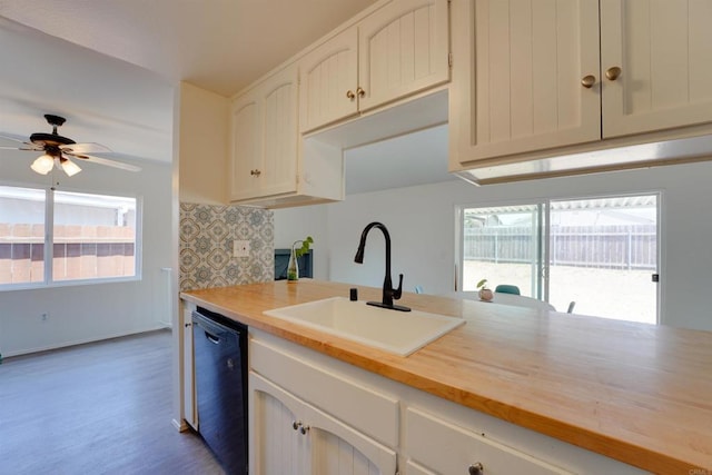 1547 Cochabamba St, San Diego, CA 92154 - kitchen with dishwasher, plenty of natural light, white cabinets, and wood finished floors
