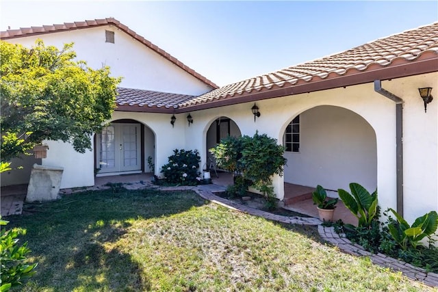 65380 San Lucas Rd, Lockwood, CA 93932 - entrance to property featuring french doors, a tile roof, stucco siding, and a lawn