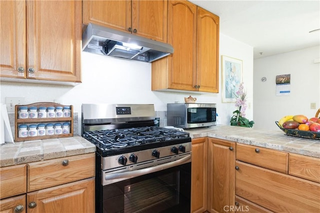 65380 San Lucas Rd, Lockwood, CA 93932 - kitchen featuring under cabinet range hood, stainless steel appliances, and light countertops