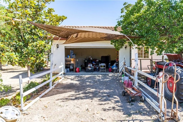 65380 San Lucas Rd, Lockwood, CA 93932 - view of side of home featuring driveway, a garage, stucco siding, and an outbuilding