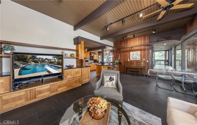 1653 W Cypress Ave, Redlands, CA 92373 - living room featuring plenty of natural light, wood walls, a ceiling fan, a wood ceiling with exposed beams, and dark tile patterned floors