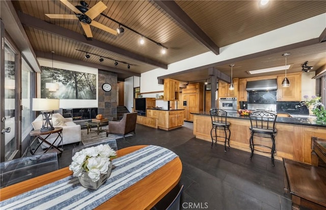1653 W Cypress Ave, Redlands, CA 92373 - dining space with a ceiling fan, a wooden ceiling with exposed beams, and rail lighting