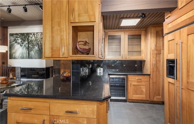 1653 W Cypress Ave, Redlands, CA 92373 - kitchen featuring beverage cooler, paneled built in fridge, tasteful backsplash, dark tile patterned floors, and dark stone counters