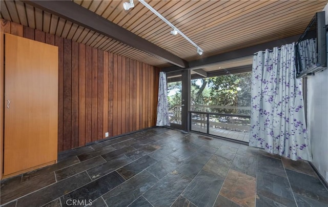 1653 W Cypress Ave, Redlands, CA 92373 - spare room with wood walls, beamed ceiling, and stone finish flooring
