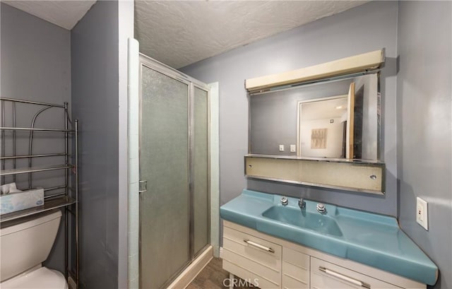 1653 W Cypress Ave, Redlands, CA 92373 - bathroom with a shower stall, vanity, wood finished floors, and a textured ceiling