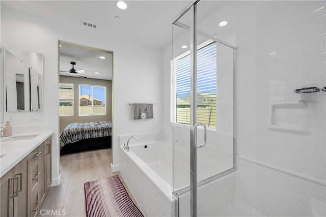 27741 Solitude Ave, Moreno Valley, CA 92555 - bathroom with double vanity, plenty of natural light, wood finished floors, ceiling fan, and recessed lighting