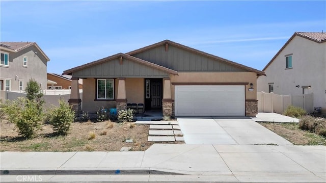 27741 Solitude Ave, Moreno Valley, CA 92555 - view of front of home with stucco siding, stone siding, covered porch, and an attached garage