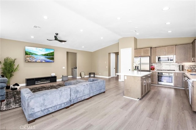 27741 Solitude Ave, Moreno Valley, CA 92555 - living area with lofted ceiling, light wood-style floors, and recessed lighting