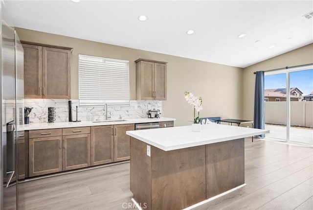 27741 Solitude Ave, Moreno Valley, CA 92555 - kitchen featuring light wood-style floors, stainless steel fridge with ice dispenser, backsplash, light countertops, and recessed lighting